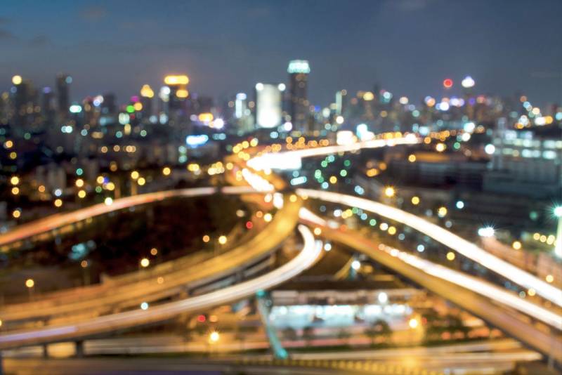 Photo of a city with busy traffic at night.