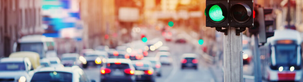 Photo of a traffic light in a busy city.