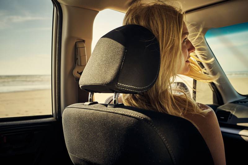 Photo of woman having a relaxing car ride.